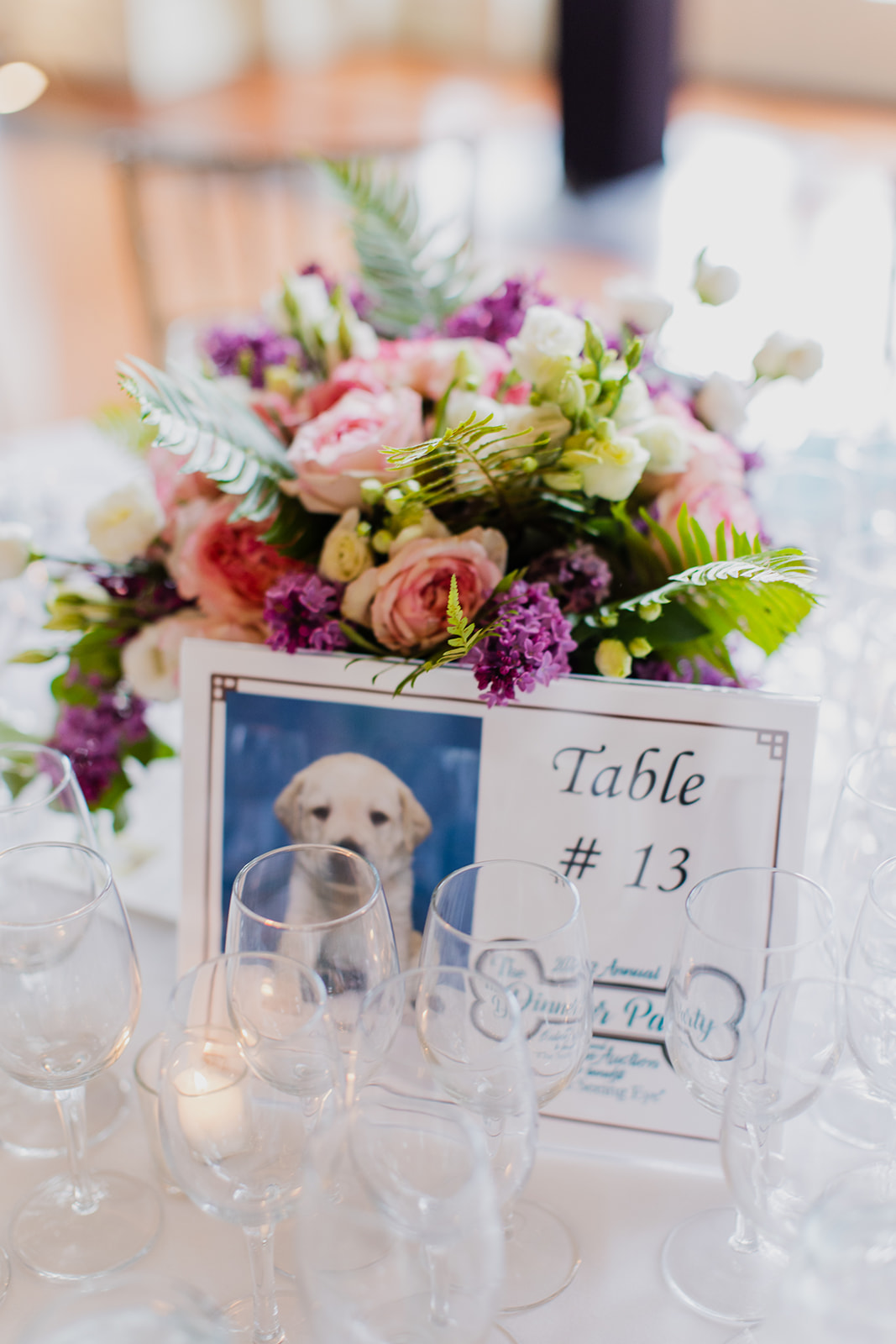A close-up of the table arrangements. Center pieces consisted of a photo of a Seeing Eye puppy and bright spring flowers.