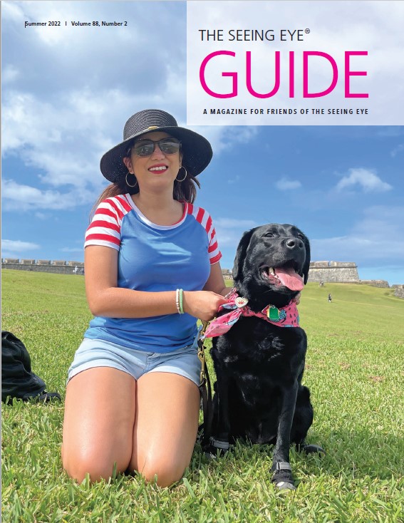 The cover of The Guide Summer 2022 shows a Seeing Eye graduate in front of El Morro in Puerto Rico.